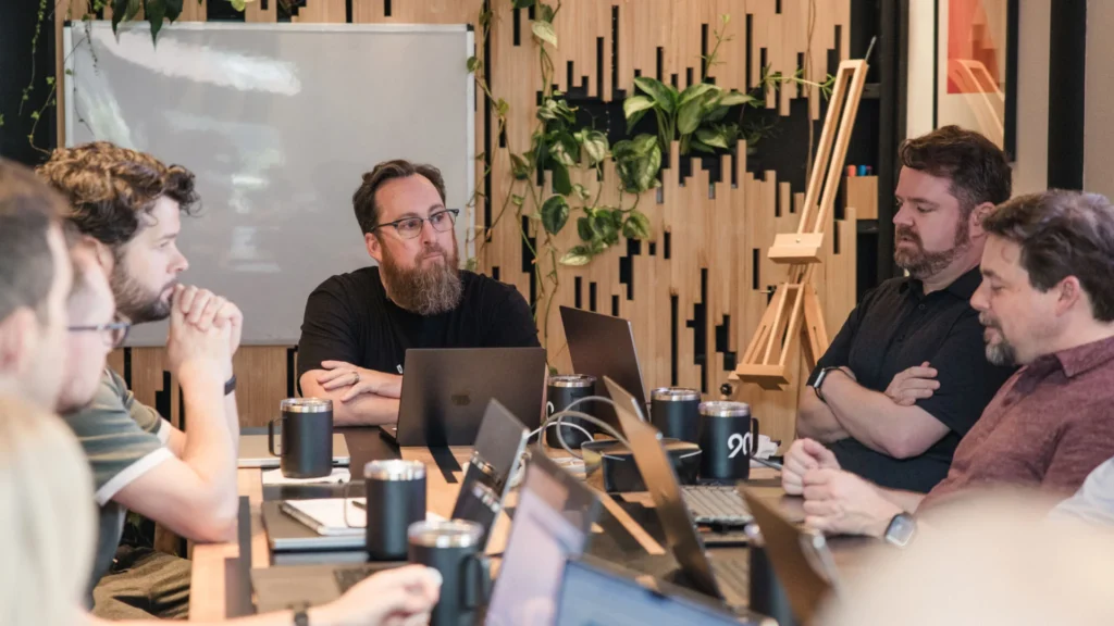 A group of professionals seated around a table, collaborating in a meeting